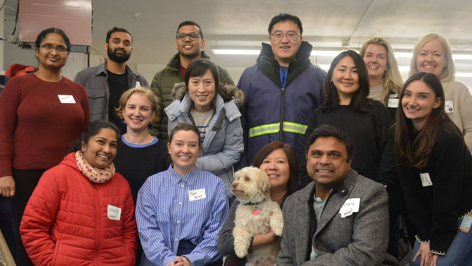 Invest in Community Group of members with name tags smiling at the camera