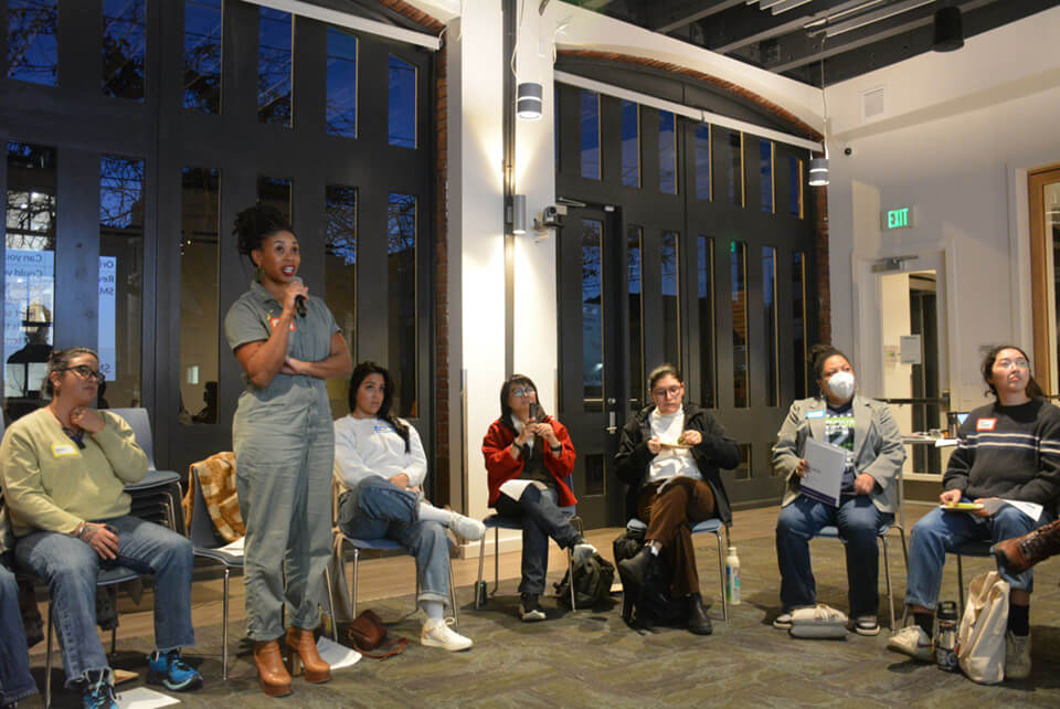 GrowFundMe Panel Woman answering a question at a panel discussion